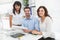 Smiling coworkers working together at desk