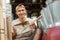 Smiling craftsman holding a dustpan trash when showing to the camera