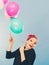 Smiling crazy girl having fun with balloons.