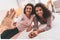 Smiling curly woman giving high five to her boyfriend