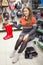 Smiling customer showing red rainboots when dressing shoes