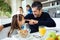 Smiling cute father and daughter having fun while having breakfast in family in the kitchen at home