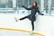 Smiling cute girl on skates on ice