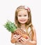 Smiling cute little girl holding ripe whole pineapple