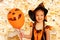 Smiling cute little girl in orange Halloween dress