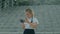 Smiling cute school girl playing with smartphone. Cheerful 8 y.o. girl touching mobile phone with fingers, looking