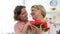 Smiling daughter hugging senior mother, holding tulips gift, holiday greetings