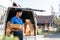 Smiling delivery asian man standing in front of his van. Portrait of courier delivering parcel package