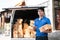 Smiling delivery asian man standing in front of his van. Portrait of courier delivering parcel package