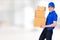 Smiling delivery man carrying parcel box
