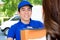 Smiling delivery man delivering a package