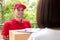 Smiling delivery man delivering parcel to a woman