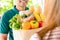 Smiling delivery man giving grocery bag to woman customer at home