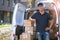 Smiling delivery man loading boxes into his truck