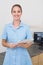 Smiling dental assistant looking at camera holding clipboard