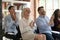 Smiling diverse coworkers applaud thanking for seminar speech