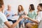 Smiling Diverse Women Sitting In Circle During Group Therapy Indoor