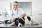 Smiling Doctor Examining Border Collie\'s Ear With Machine