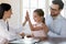 Smiling doctor give high five to little girl patient