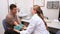 Smiling doctor measuring the blood pressure of his patient