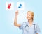 Smiling doctor or nurse pointing to pills icon