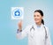 Smiling doctor or nurse pointing to pills icon