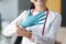 Smiling doctor puts glove on his hand