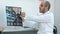 Smiling doctor showing brain computed tomography x-ray image to his patients