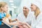 smiling doctors and patient on wheelchair