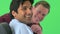 Smiling East Indian and Caucasian businessmen on greenscreen