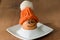 Smiling egg with knitted bonnet sitting in white eggcup