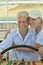 Smiling elderly couple resting on yacht