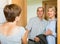 Smiling elderly family couple visiting daughter