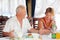 Smiling elderly having breakfast at restaurant