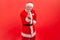 Smiling elderly man with gray beard wearing santa claus costume gesturing come to me, beckoning with