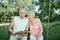 Smiling elderly man and woman 65-69 years old absorbedly readi