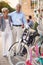 Smiling elderly woman and man buying new bicycle in shop