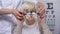Smiling elderly woman putting on phoropter, choosing proper lens diopter, test