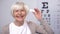 Smiling elderly woman showing lens into camera, patient choice, recommendation