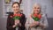 Smiling elderly women sniffing bouquet of tulips, happy mothers day, present