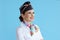 smiling elegant female air hostess on blue