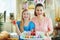 Smiling elegant mother and child showing easter plate