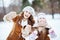 Smiling elegant mother and child showing snowy mittens