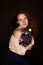 Smiling elegant redhead girl holding bouquet of cornflowers