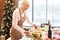 Smiling elegant senior woman serving festive holiday table with healthy foods