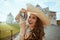 Smiling elegant solo tourist woman in floral dress