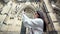 Smiling elegant woman tourist taking selfie using smartphone posing at medieval palace background