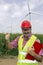 Smiling Engineer Wearing Red Safety Helmet Showing Thumb Up At W