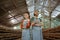 smiling entrepreneur couple wearing apron with thumbs up at farm