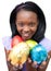 Smiling ethnic woman showing Easter eggs